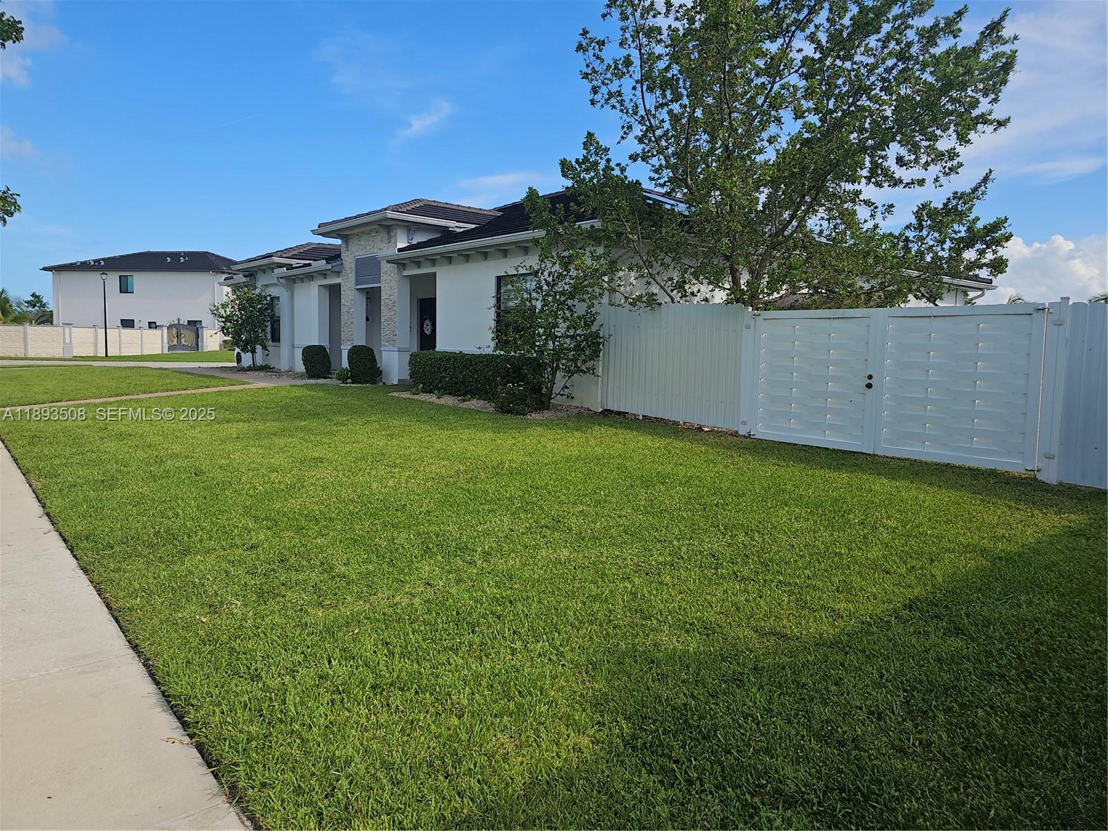 18964 Southwest 135th Avenue Miami, FL 33177 - Photo 30 of 39 a front view of a house with a garden
