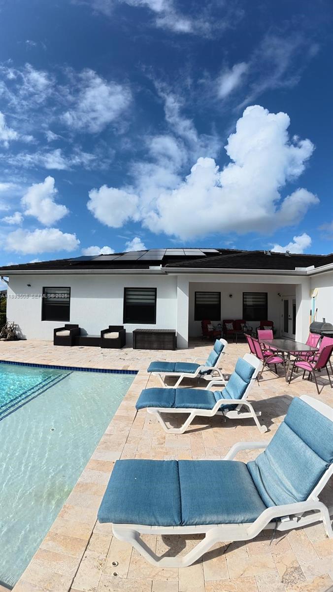 18964 Southwest 135th Avenue Miami, FL 33177 - Photo 38 of 39 a outdoor space with furniture and a fireplace