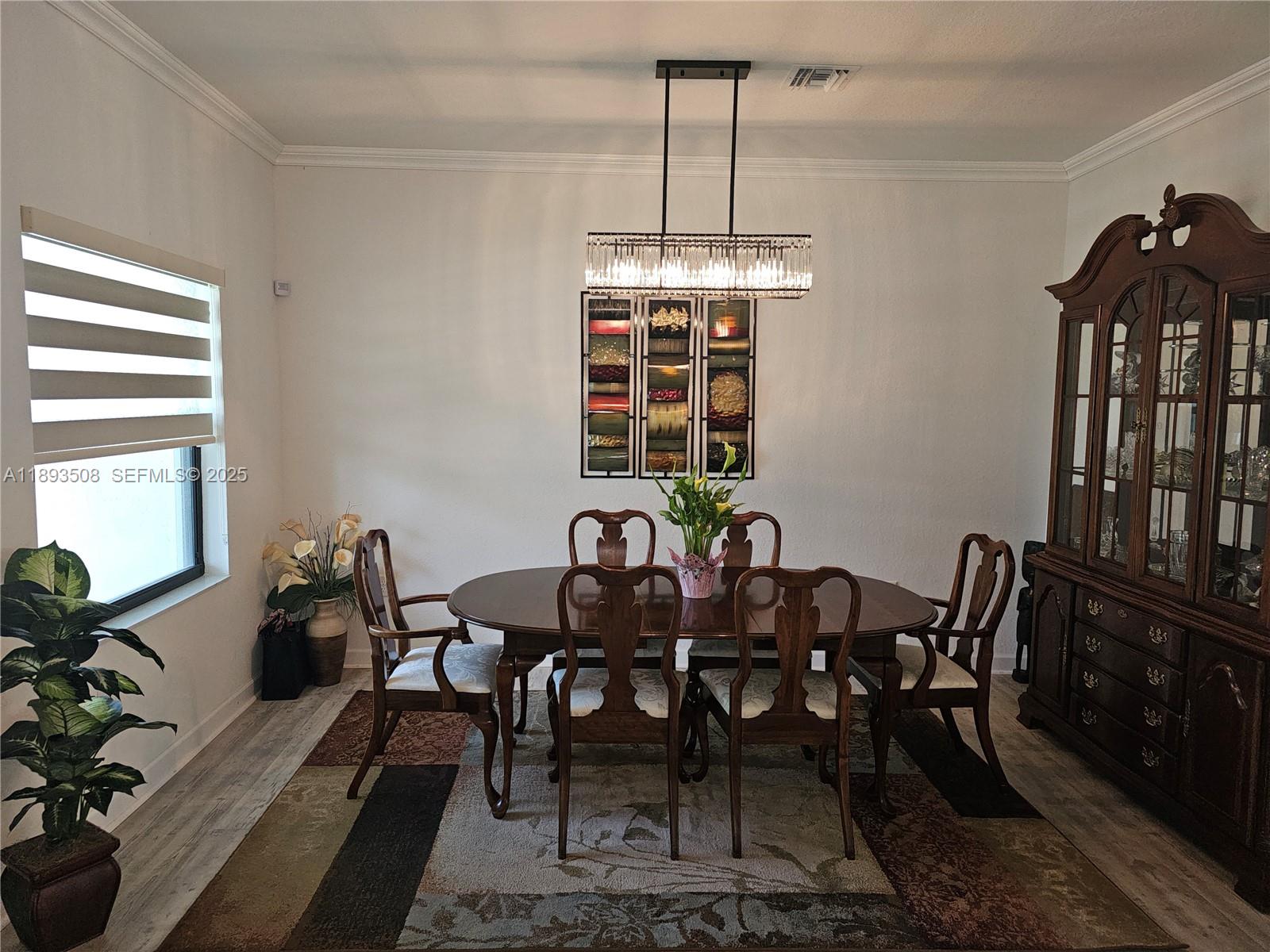 18964 Southwest 135th Avenue Miami, FL 33177 - Photo 6 of 39 a view of a dining room with furniture window and wooden floor