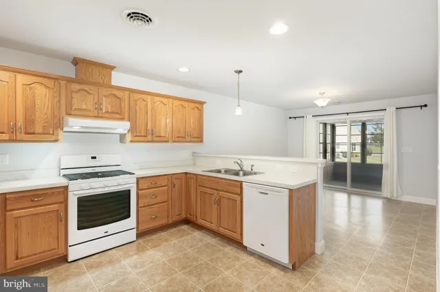 a kitchen with a sink and refrigerator