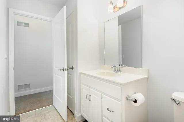 an empty room with a window and a ceiling fan