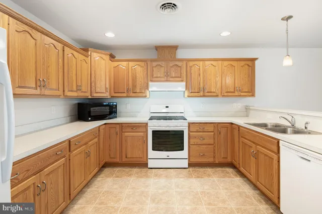 a kitchen with a sink stove and cabinets