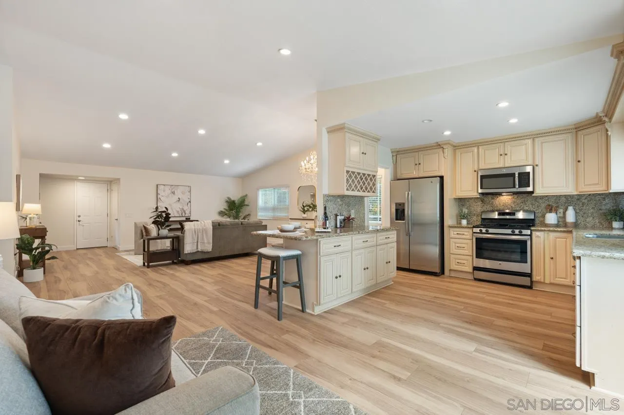 11837 La Colina Road San Diego, CA 92131 - Photo 13 of 35 a large kitchen with kitchen island a large counter top stainless steel appliances and cabinets