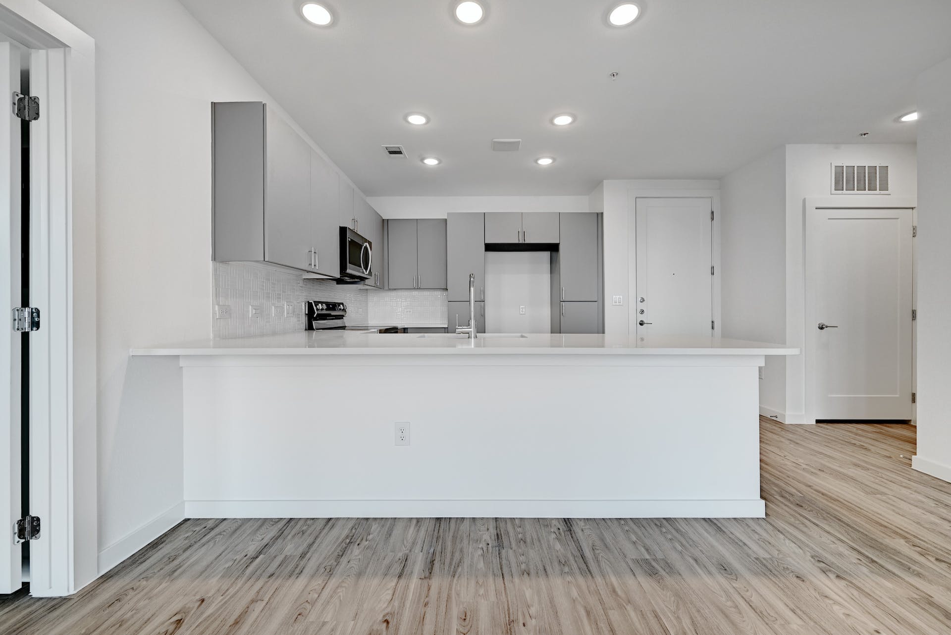 4801 Springdale Road, Unit 1301 Austin, TX 78723 - Photo 6 of 39 Modern kitchen with white countertops and light-toned flooring.