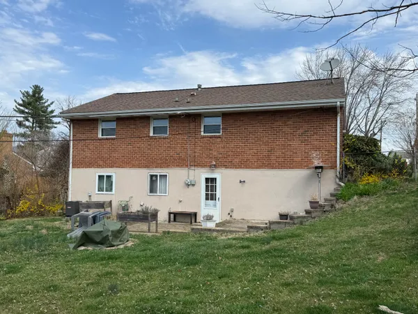 a view of a house with a backyard