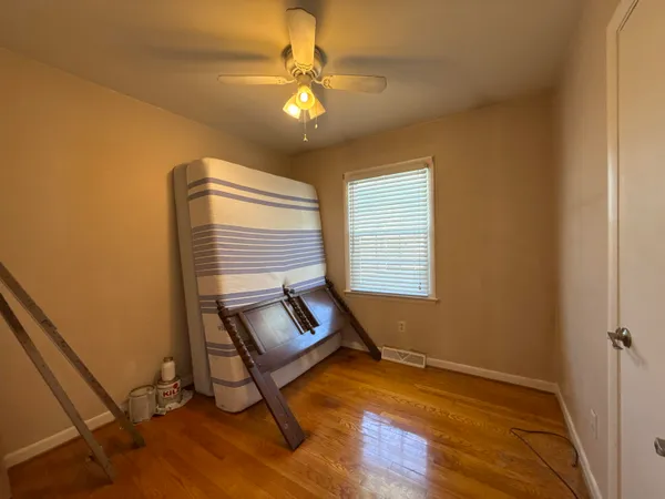 a view of room with window and wooden floor
