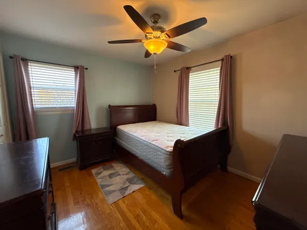 a bed sitting in a room next to a window