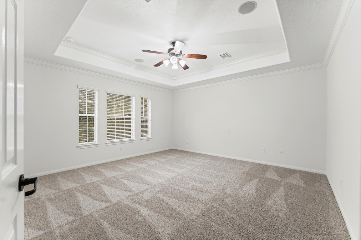 133 East Montfair Boulevard The Woodlands, TX 77382 - Photo 11 of 20 an empty room with windows and ceiling fan view