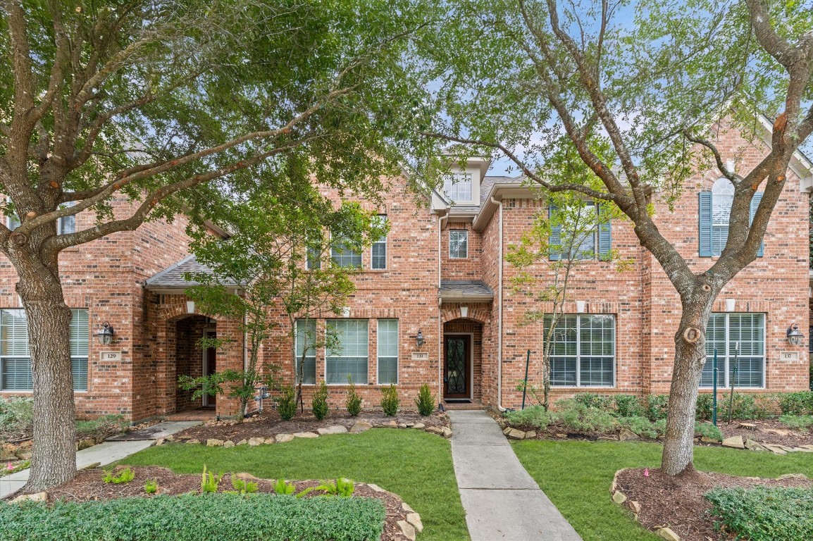 133 East Montfair Boulevard The Woodlands, TX 77382 - Photo 2 of 20 front view of a brick house with a yard