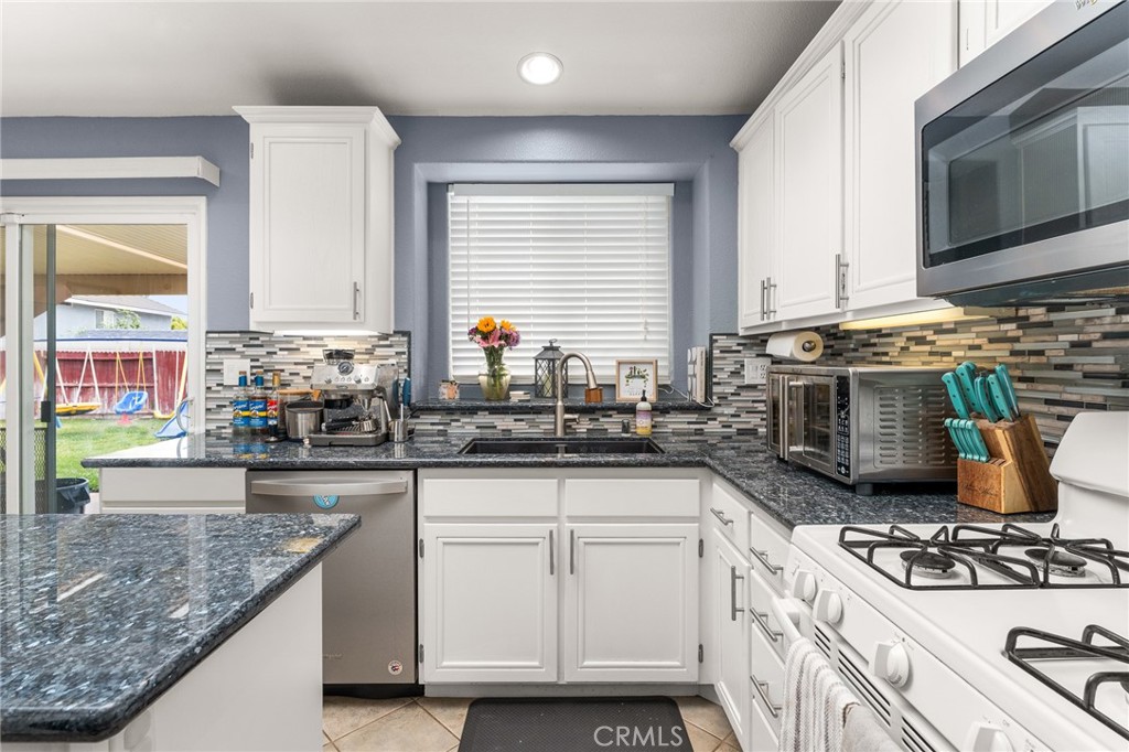 533 Heidi Circle Beaumont, CA 92223 - Photo 11 of 37 a kitchen with stainless steel appliances granite countertop a stove and a sink