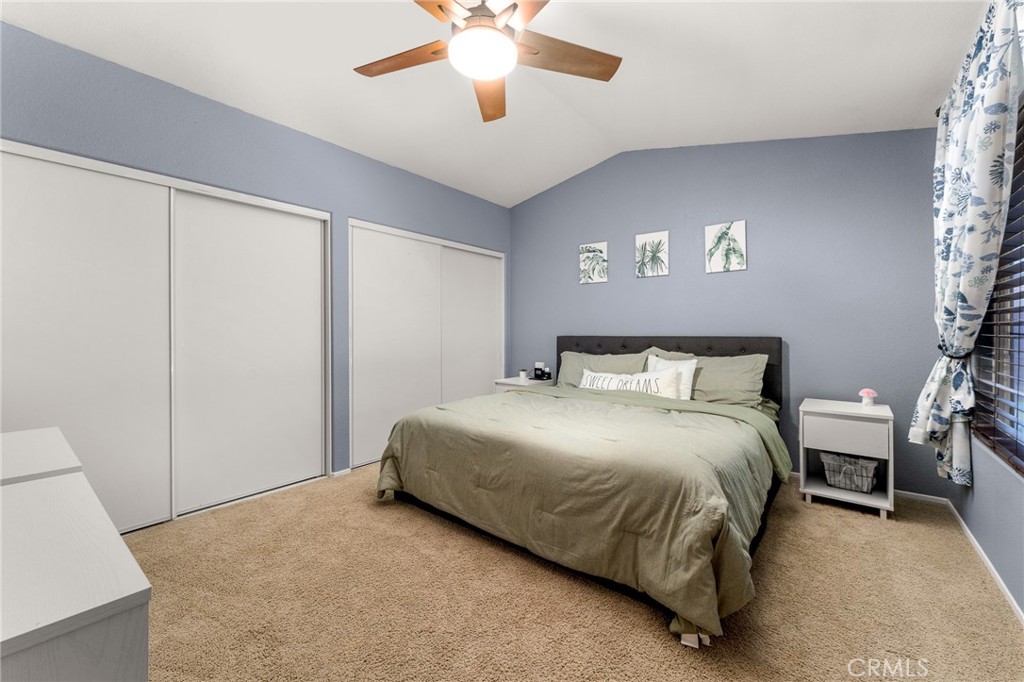 533 Heidi Circle Beaumont, CA 92223 - Photo 19 of 37 a bedroom with a bed and a chandelier