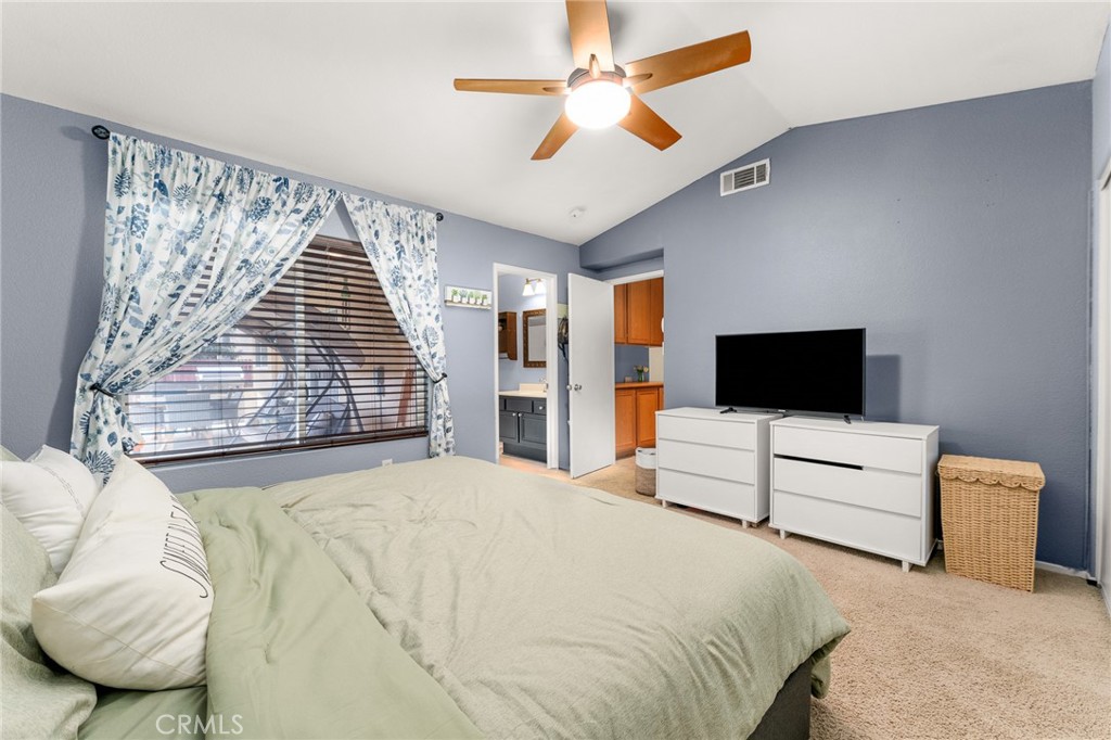 533 Heidi Circle Beaumont, CA 92223 - Photo 20 of 37 a bedroom with a bed and a flat screen tv