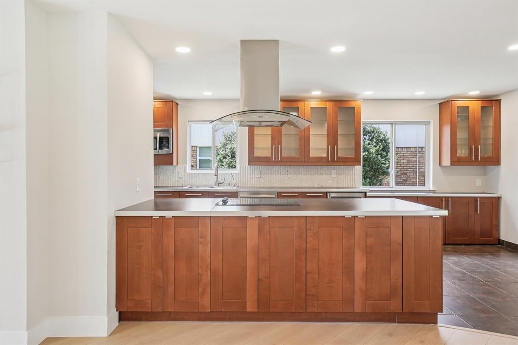 3237 Timberview Road Dallas, TX 75229 - Photo 11 of 30 Expansive island with warm wood cabinetry and modern hardware