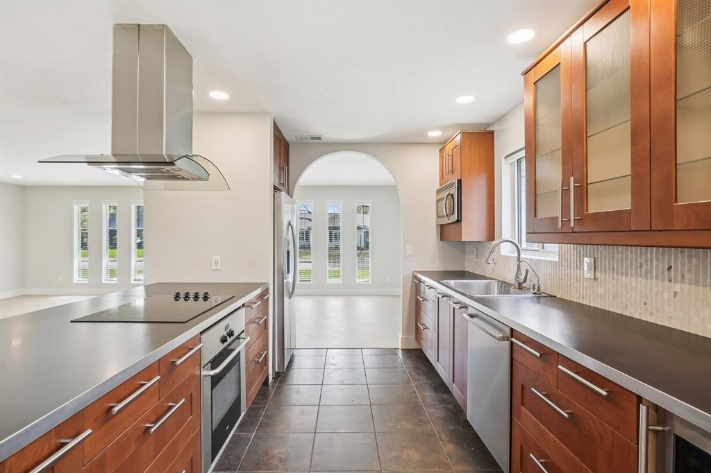 3237 Timberview Road Dallas, TX 75229 - Photo 12 of 30 Glass-front uppers, Stainless appliances and elegant backsplash