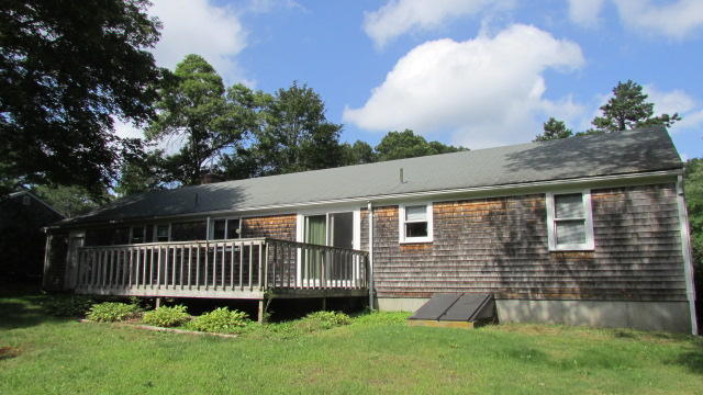 43 Chappaquiddick Road Centerville, MA 02632 - Photo 4 of 8 a front view of a house with a garden and deck