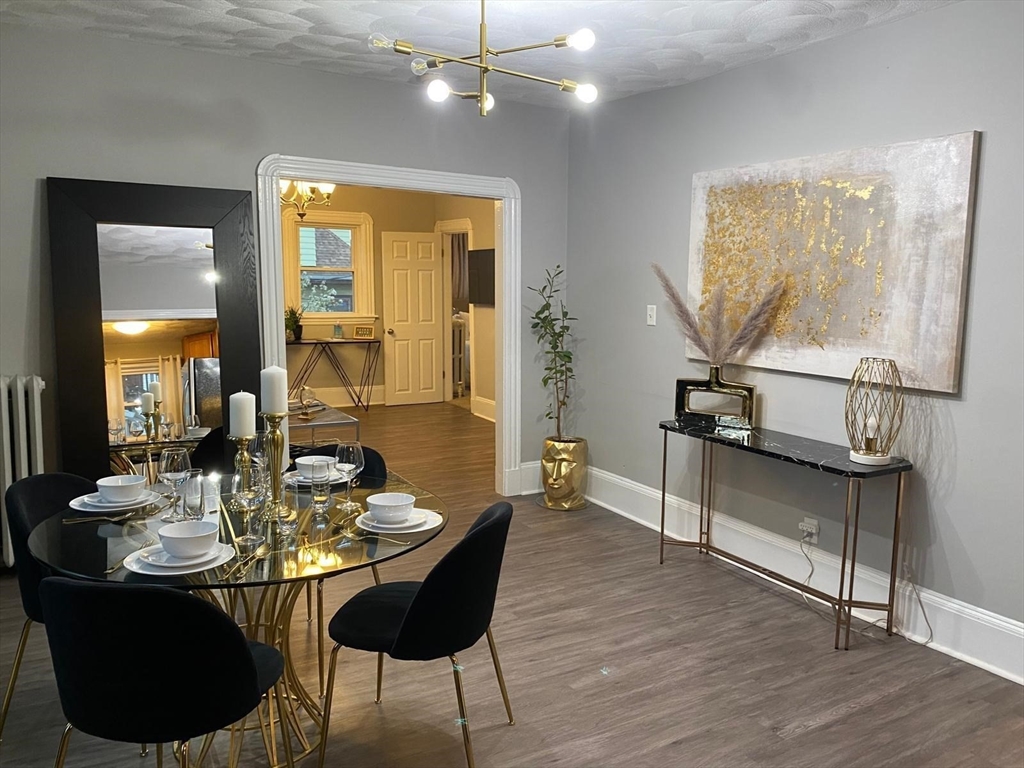 9 Henry Street, Unit 2 Everett, MA 02149 - Photo 1 of 19 a view of a dining room with furniture and wooden floor