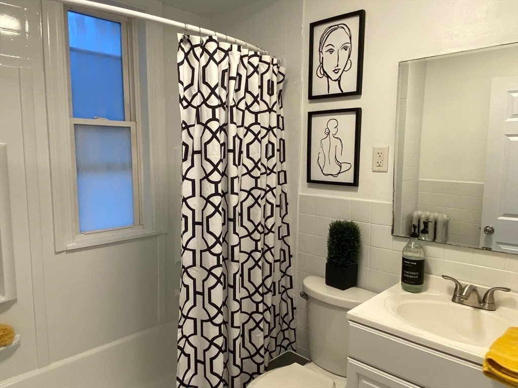 9 Henry Street, Unit 2 Everett, MA 02149 - Photo 11 of 19 a bathroom with a toilet and a sink