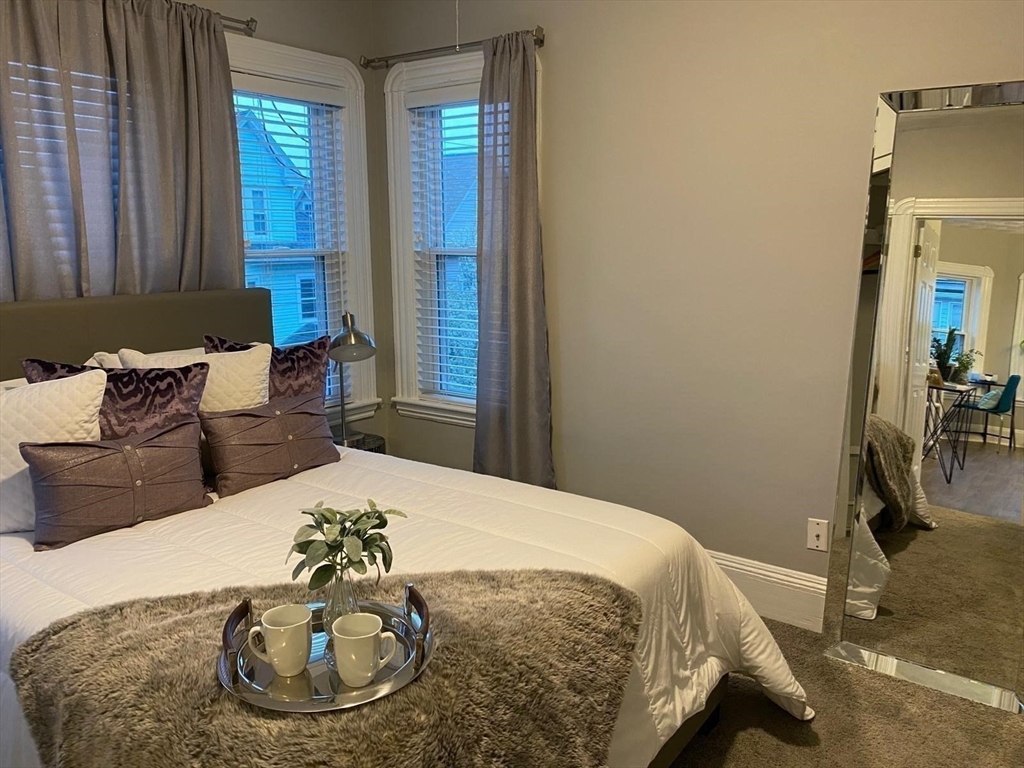 9 Henry Street, Unit 2 Everett, MA 02149 - Photo 13 of 19 a bedroom with a bed and gym equipment