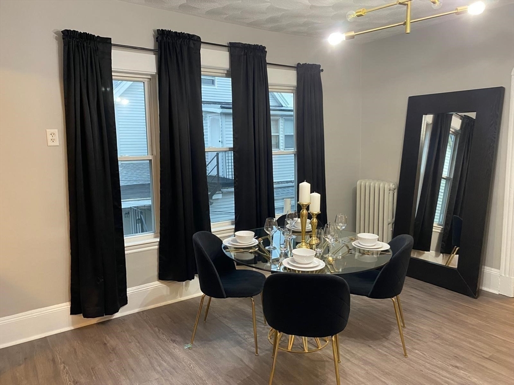 9 Henry Street, Unit 2 Everett, MA 02149 - Photo 2 of 19 a view of a dining room with furniture window and wooden floor