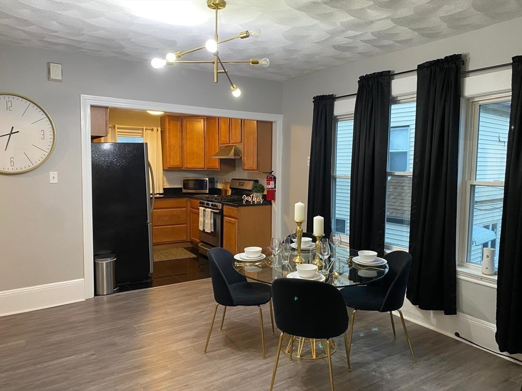 9 Henry Street, Unit 2 Everett, MA 02149 - Photo 3 of 19 a view of a dining room with furniture window and wooden floor