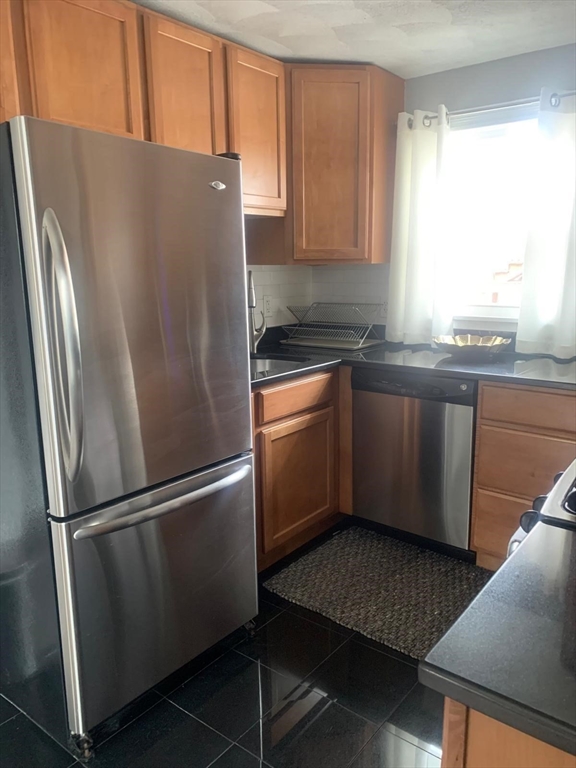 9 Henry Street, Unit 2 Everett, MA 02149 - Photo 8 of 19 a metallic refrigerator freezer sitting in a kitchen