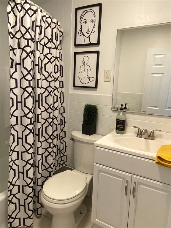 9 Henry Street, Unit 2 Everett, MA 02149 - Photo 10 of 19 a bathroom with a toilet and a sink