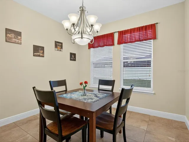 a view of a dining room with furniture wooden floor and chandelier