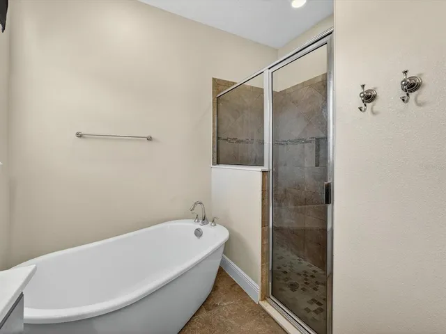 a bathroom with a bathtub and shower