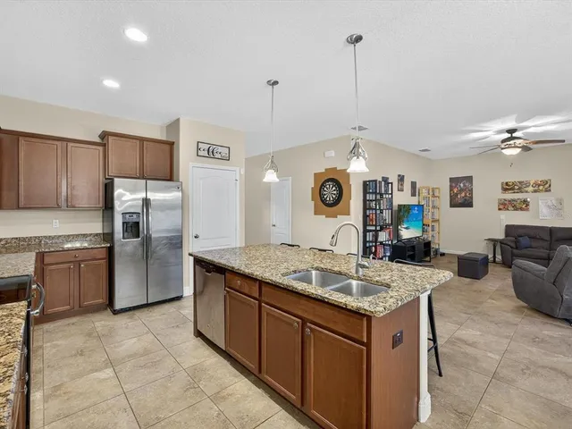 a kitchen with stainless steel appliances granite countertop a stove oven and a refrigerator