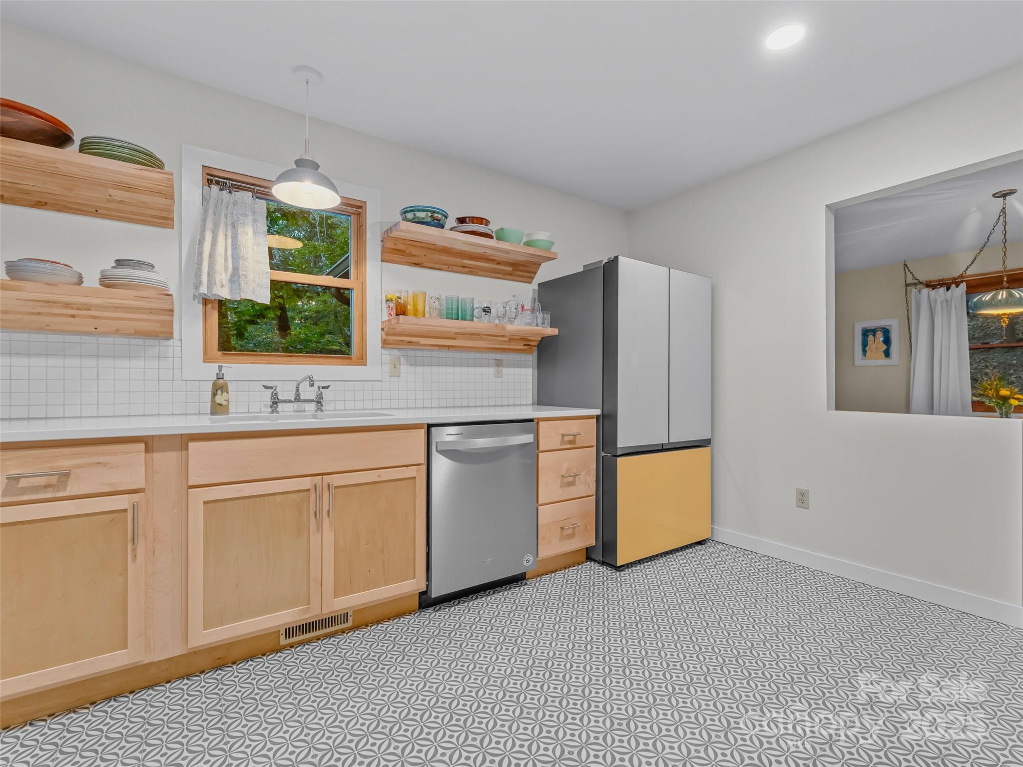 197 Tiptop Road Brevard, NC 28712 - Photo 21 of 45 a kitchen with stainless steel appliances granite countertop a refrigerator a stove and a sink