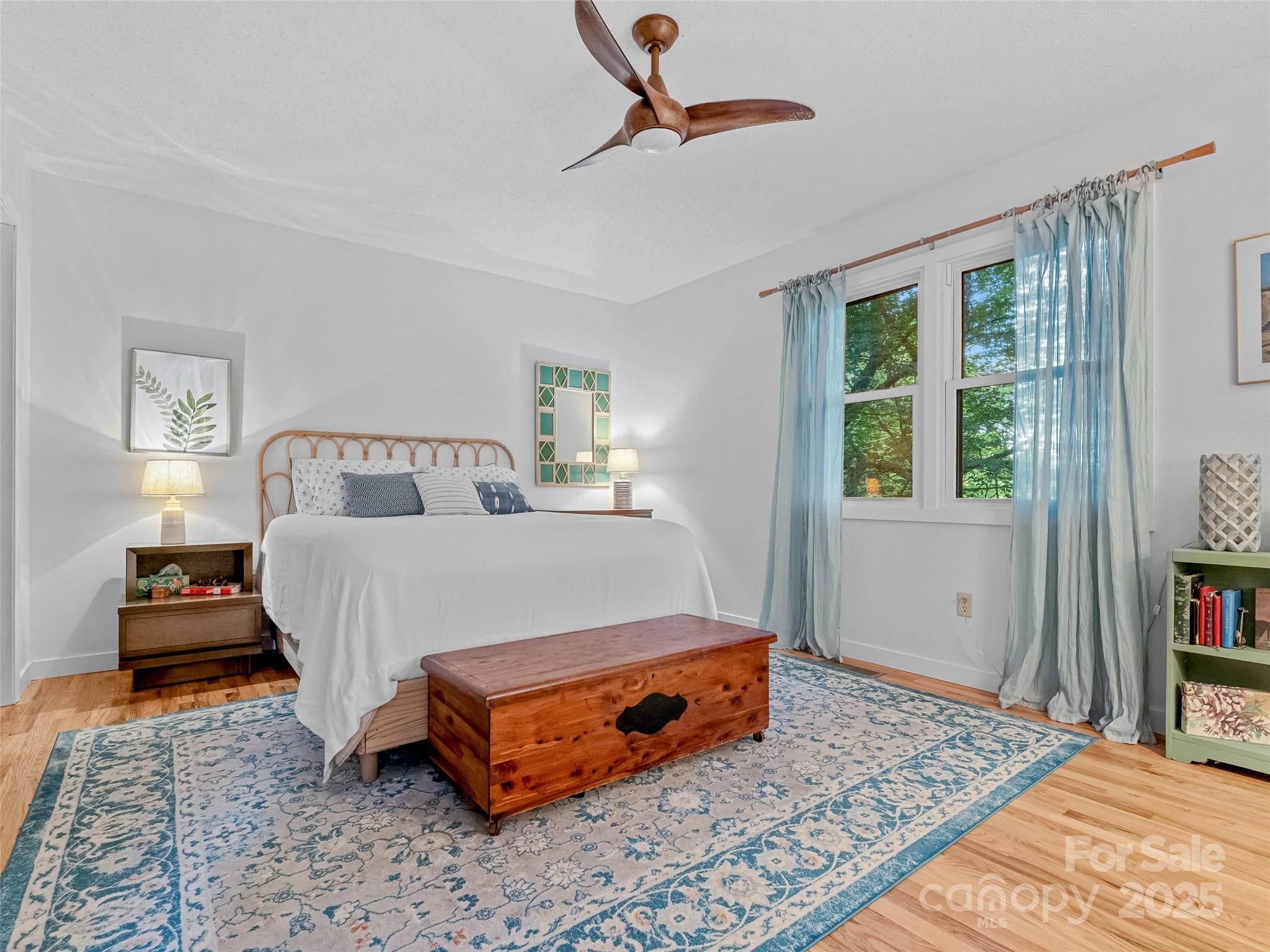 197 Tiptop Road Brevard, NC 28712 - Photo 23 of 45 a bedroom with a bed and wooden floor