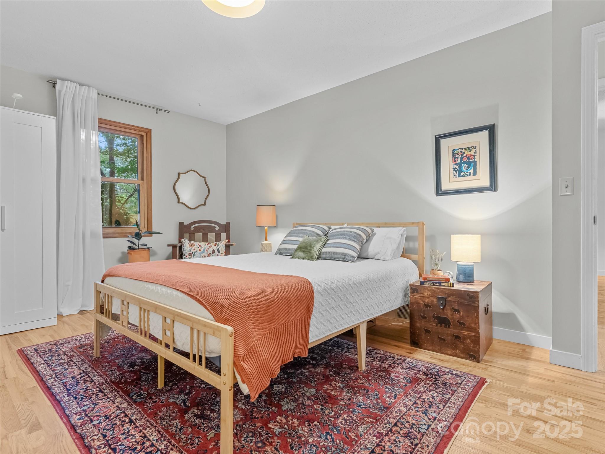 197 Tiptop Road Brevard, NC 28712 - Photo 25 of 45 a bedroom with a bed and a table in it