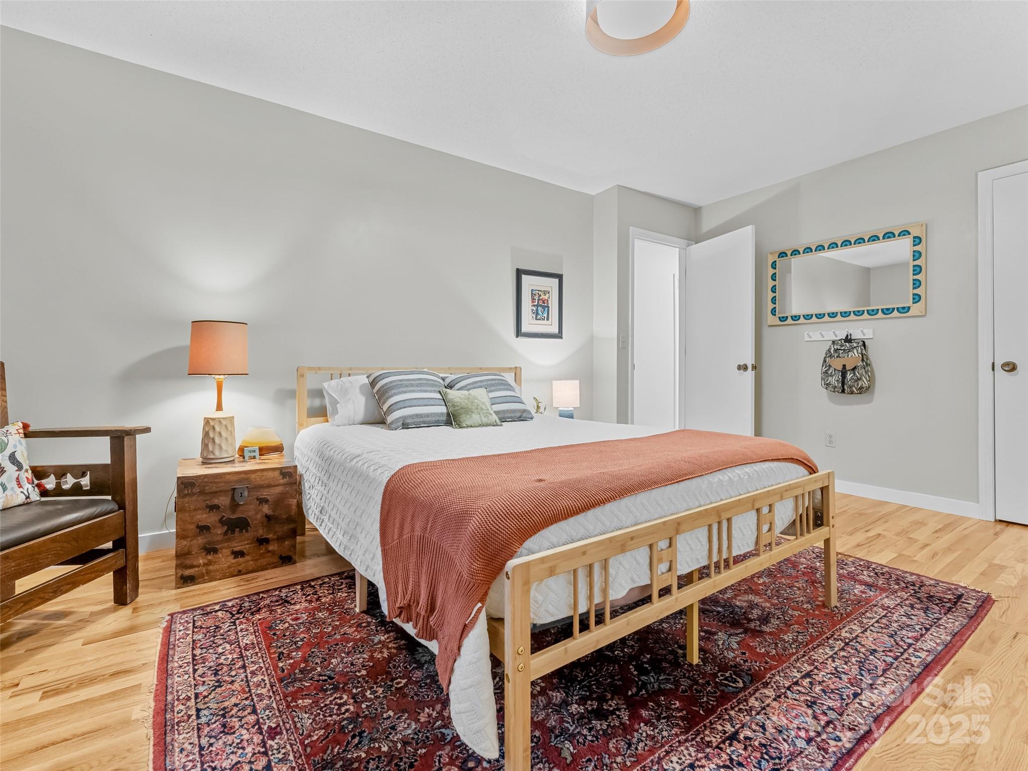 197 Tiptop Road Brevard, NC 28712 - Photo 26 of 45 a bedroom with bed and wooden floor