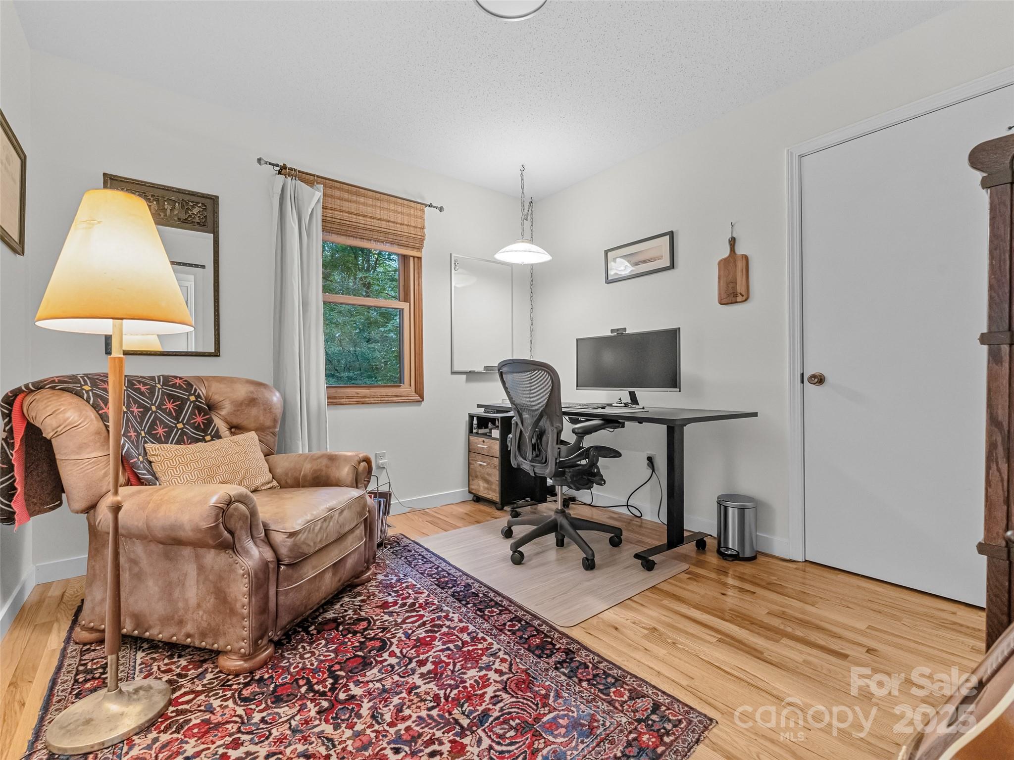 197 Tiptop Road Brevard, NC 28712 - Photo 28 of 45 a living room with furniture a lamp and a window