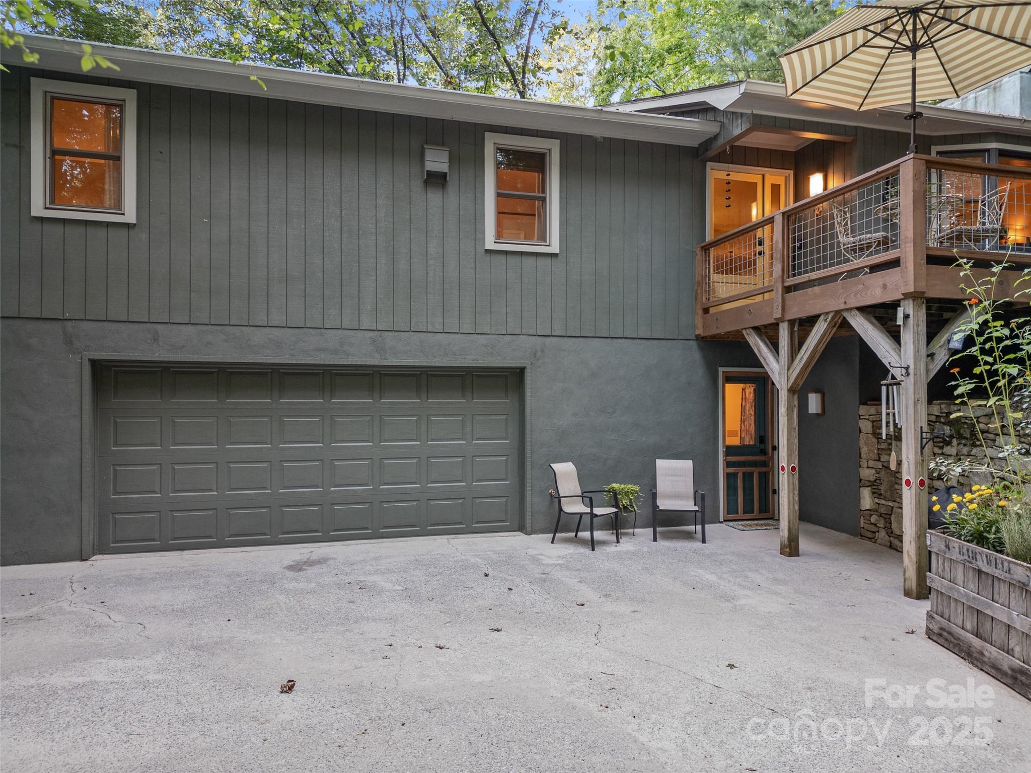 197 Tiptop Road Brevard, NC 28712 - Photo 3 of 45 a front view of a house with a yard and garage