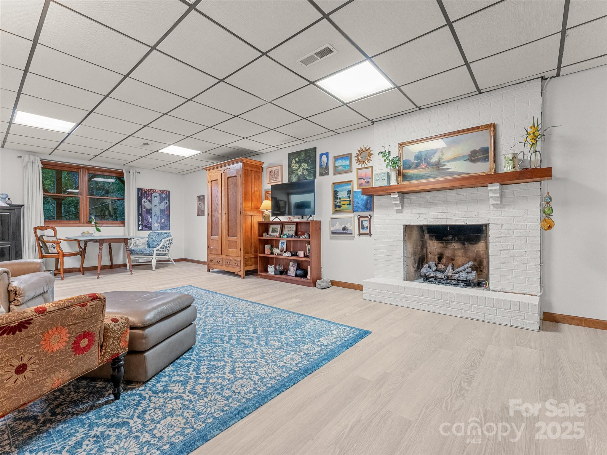 197 Tiptop Road Brevard, NC 28712 - Photo 32 of 45 a living room with furniture and a fireplace