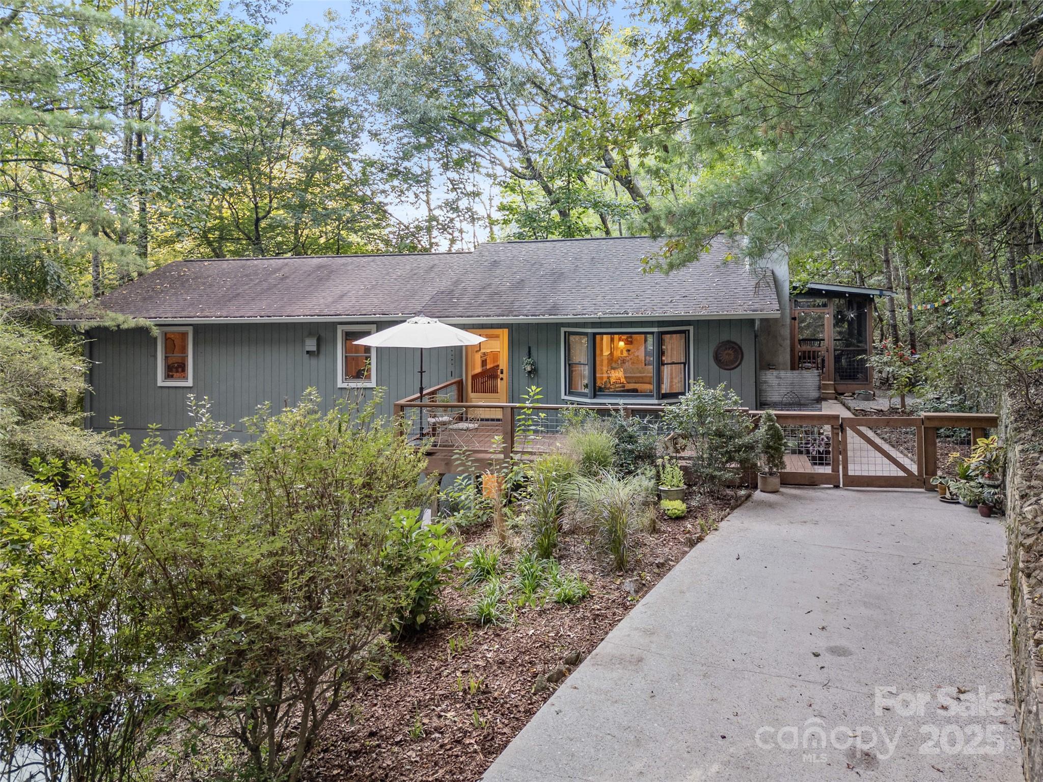 197 Tiptop Road Brevard, NC 28712 - Photo 38 of 45 a house that has a tree in front of it