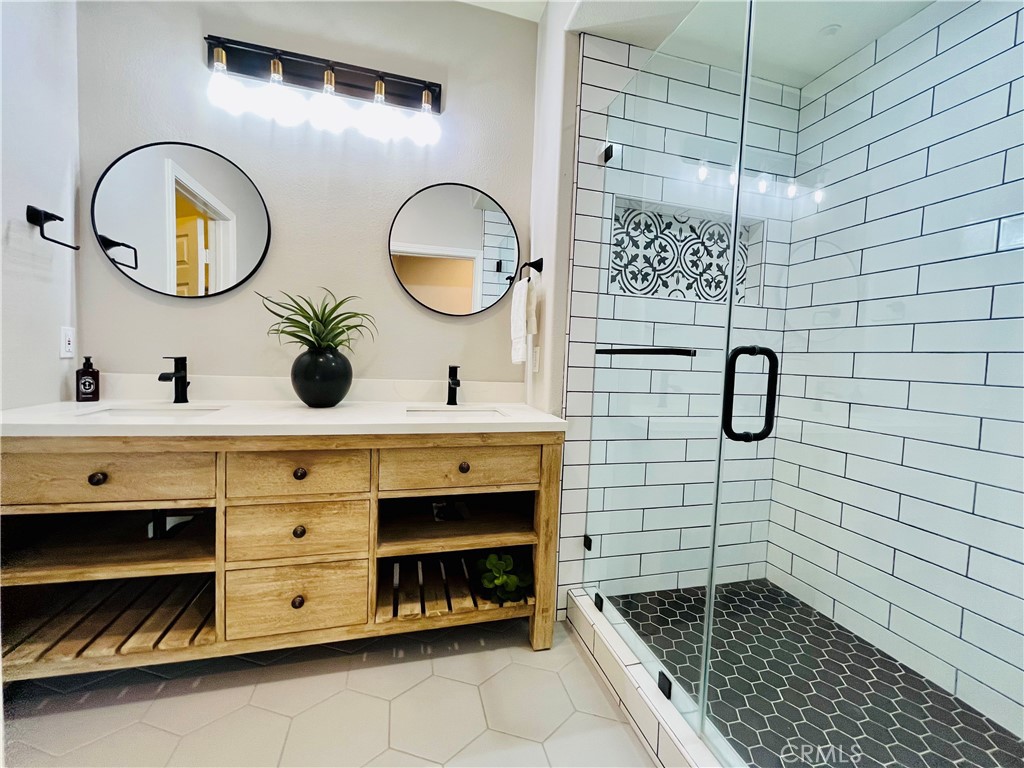 60 Strawflower Street Ladera Ranch, CA 92694 - Photo 11 of 22 a bathroom with a double vanity sink and a mirror