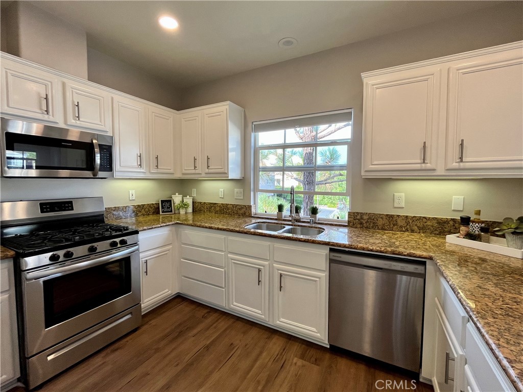 60 Strawflower Street Ladera Ranch, CA 92694 - Photo 6 of 22 a kitchen with granite countertop wooden cabinets and a stove