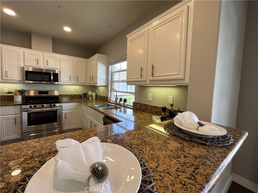 60 Strawflower Street Ladera Ranch, CA 92694 - Photo 7 of 22 a kitchen with a stove a sink and a refrigerator