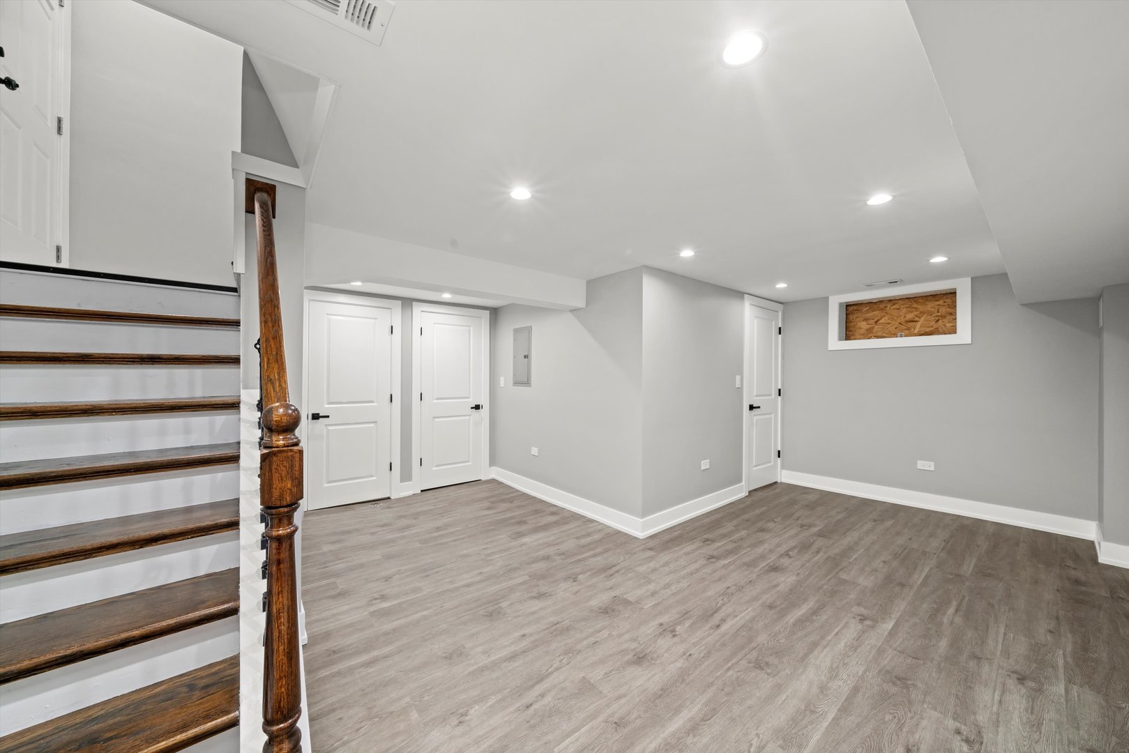 10047 South Calumet Avenue Chicago, IL 60628 - Photo 11 of 32 a view of an empty room with wooden floor and a window