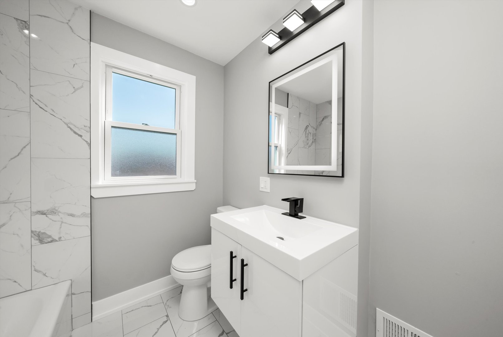 10047 South Calumet Avenue Chicago, IL 60628 - Photo 13 of 32 a bathroom with a toilet sink and mirror