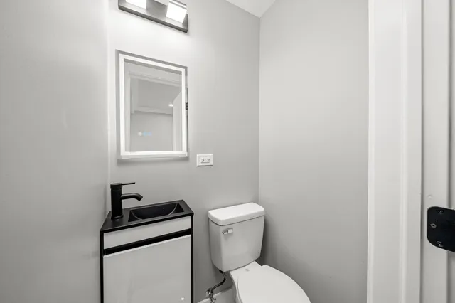 a white toilet sitting next to a bathroom sink