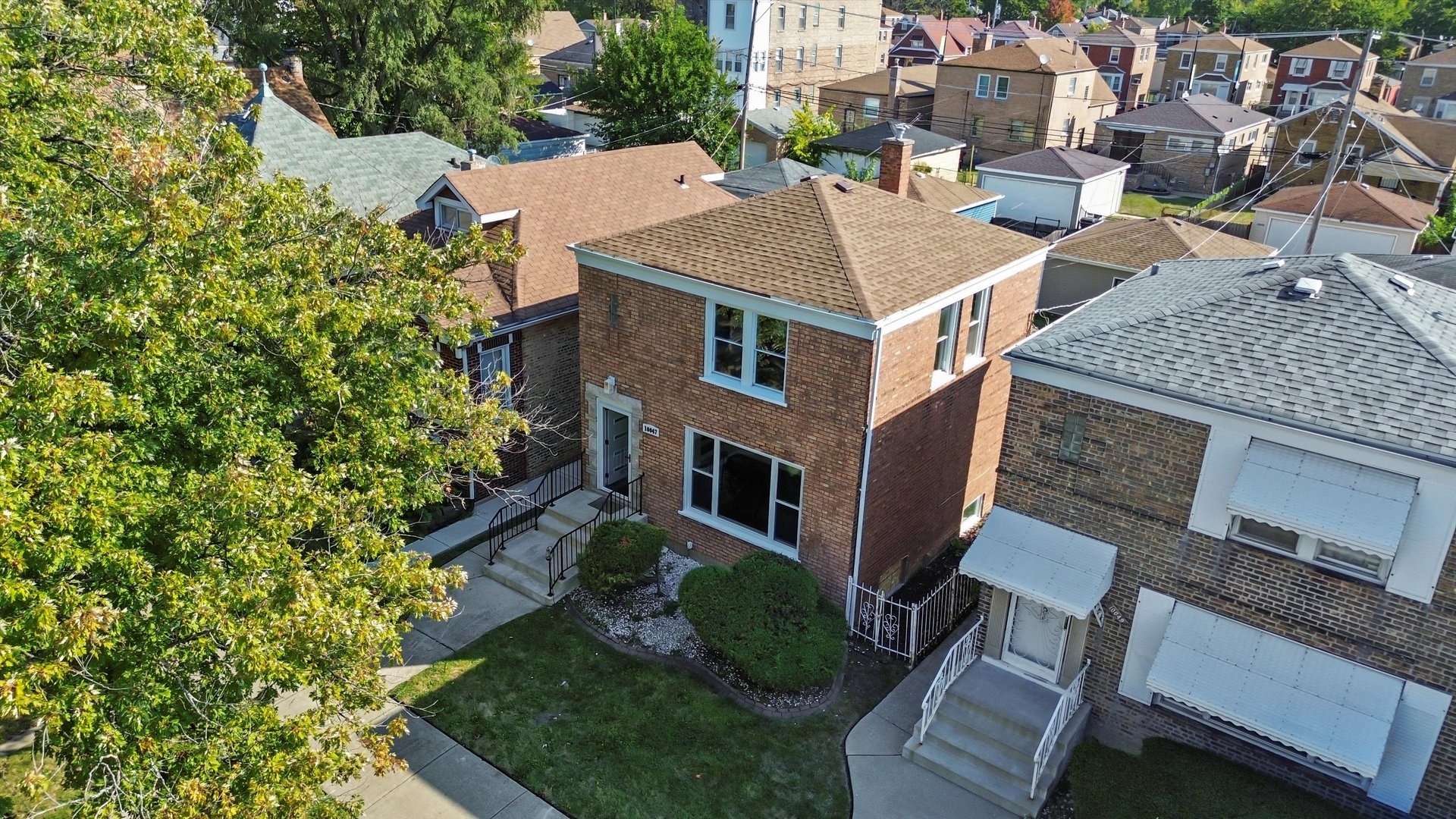 10047 South Calumet Avenue Chicago, IL 60628 - Photo 28 of 32 an aerial view of a house with a yard table and chairs