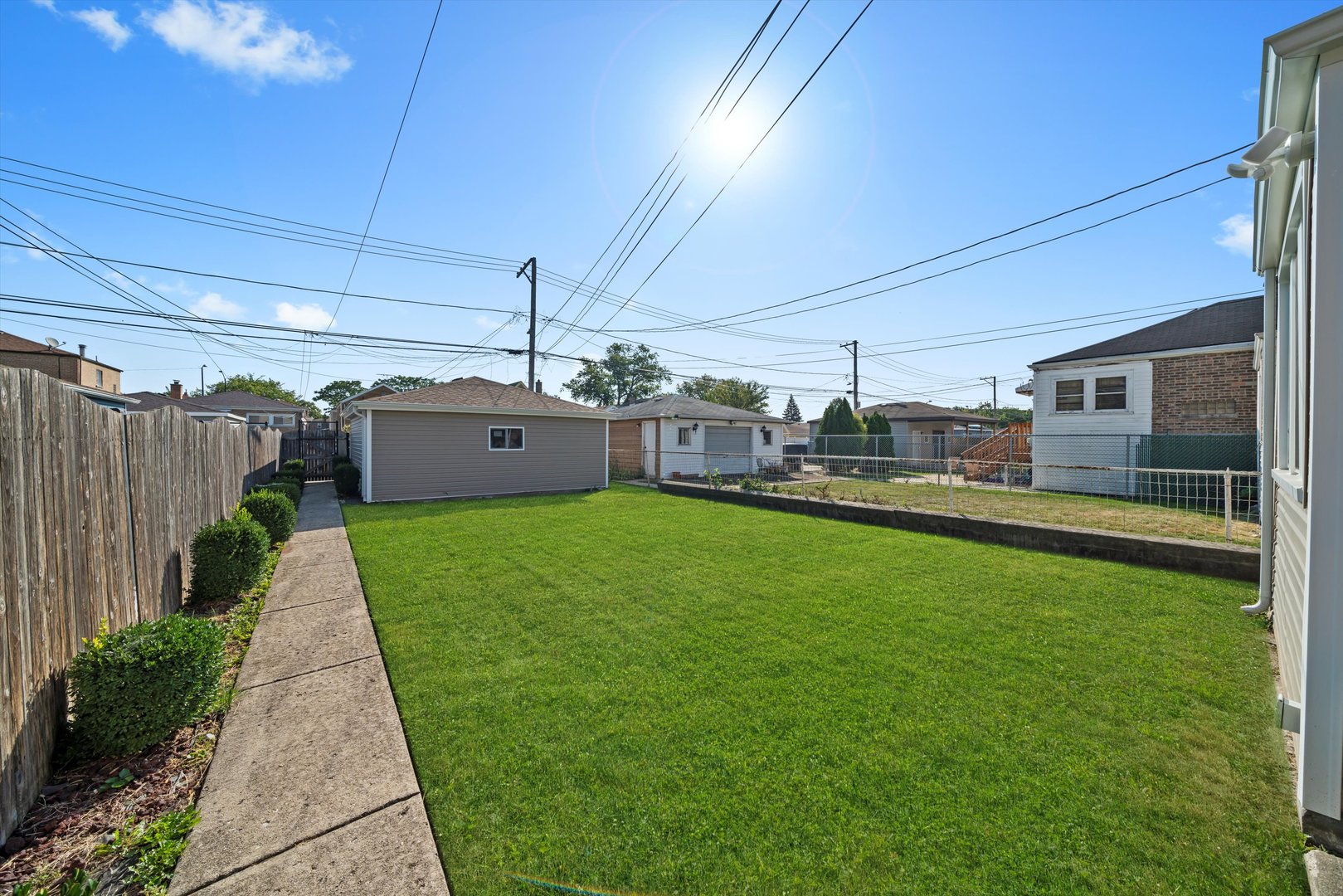 10047 South Calumet Avenue Chicago, IL 60628 - Photo 3 of 32 a front view of a house with a yard
