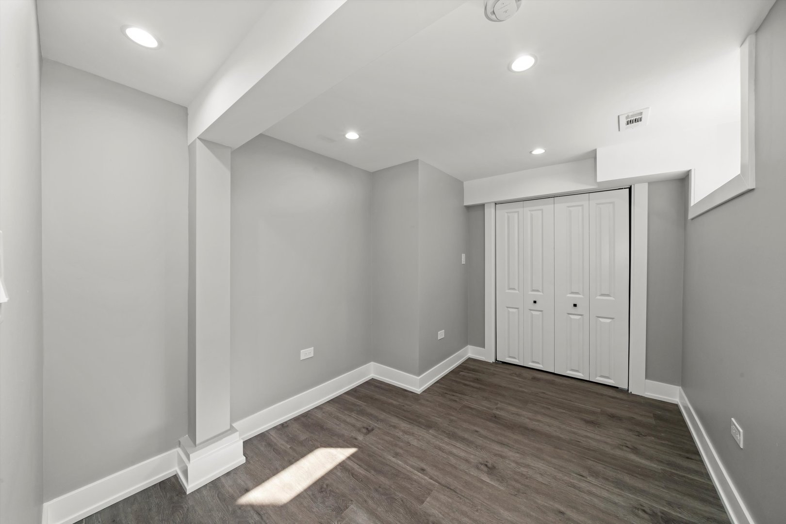 10047 South Calumet Avenue Chicago, IL 60628 - Photo 8 of 32 a view of an empty room with wooden floor