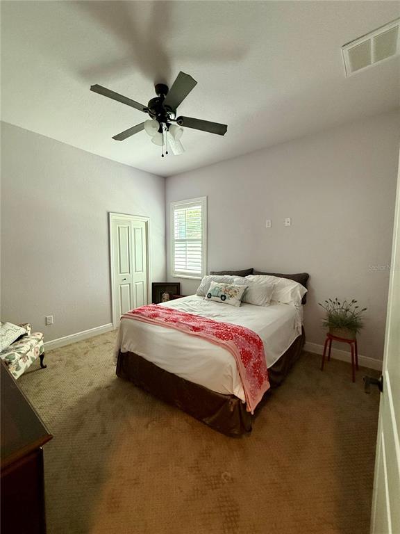 13110 Bamboo Street Spring Hill, FL 34609 - Photo 35 of 56 a bedroom with a bed and a chandelier