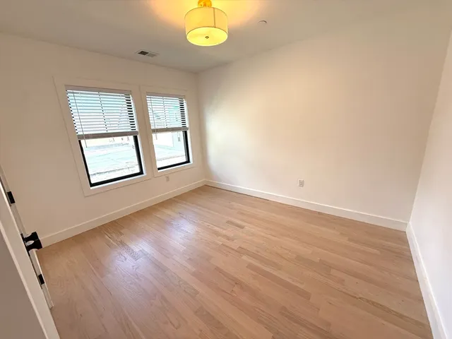 a bedroom with a bed lamps and window