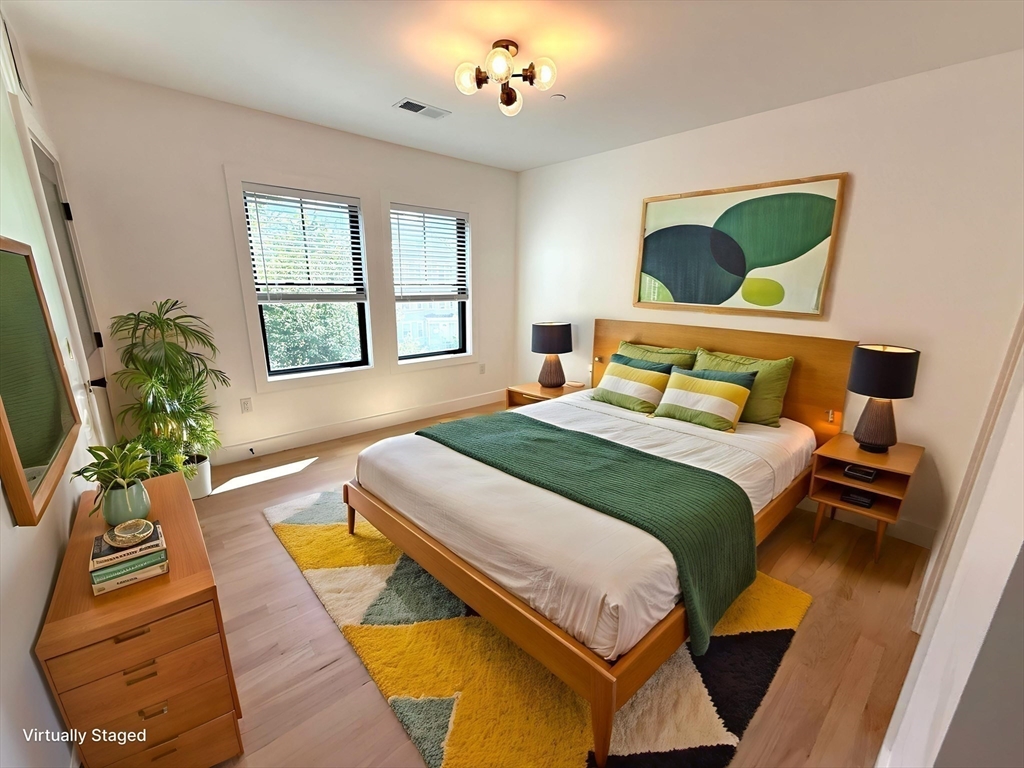 52 Withington Street, Unit 7 Boston, MA 02124 - Photo 13 of 32 a bedroom with a bed lamps and window