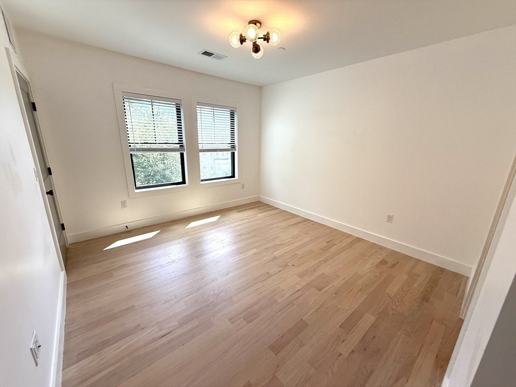52 Withington Street, Unit 7 Boston, MA 02124 - Photo 14 of 32 wooden floor in an empty room with a window